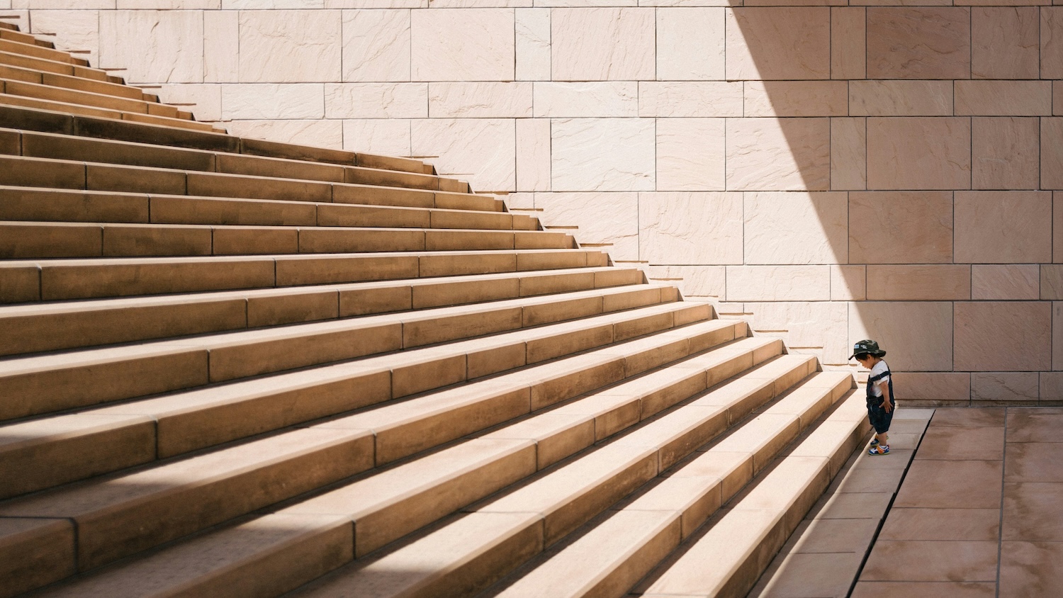 toddler standing in front of stairs